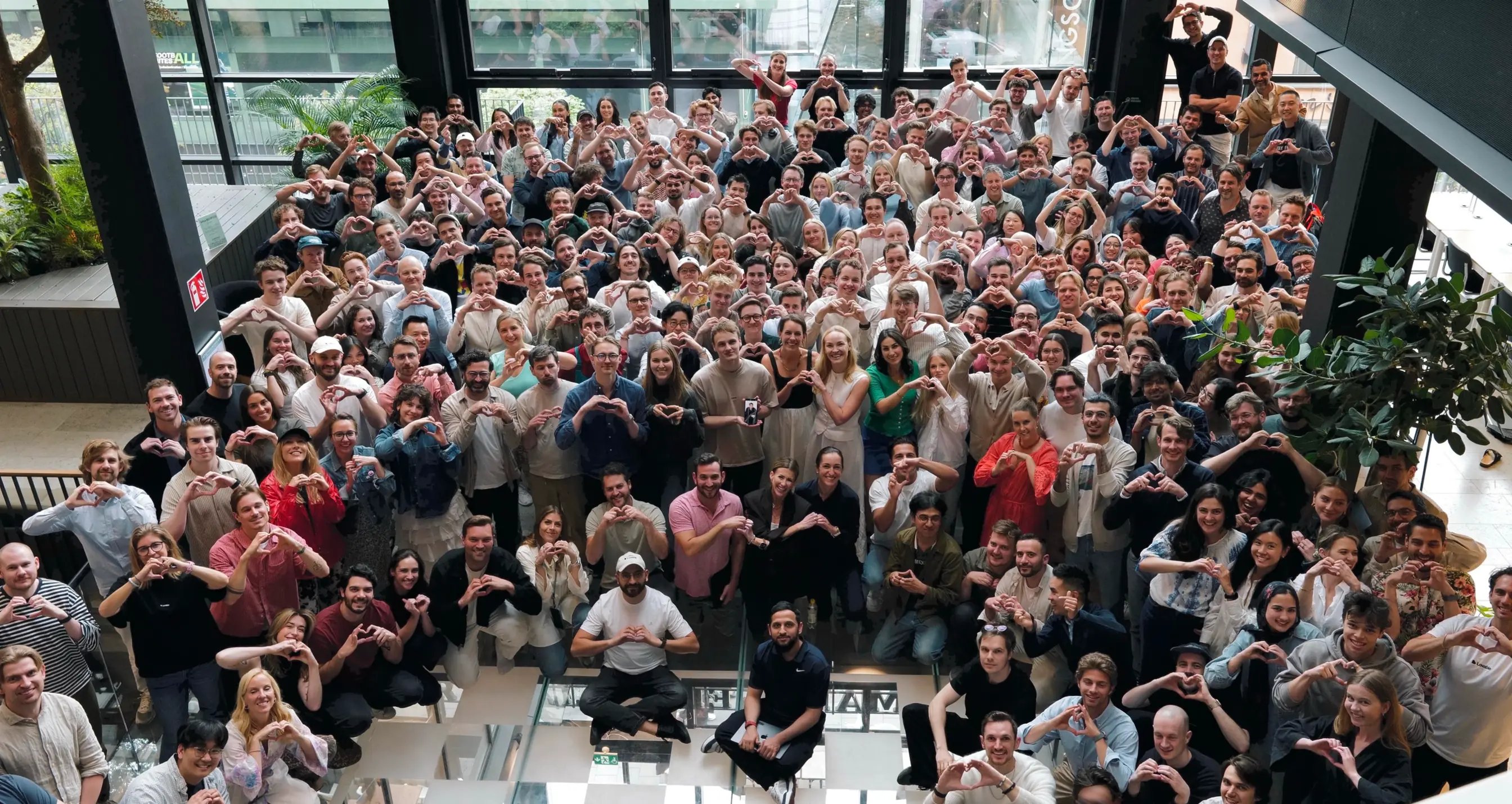 The Lovable team making heart signs in the office atrium
